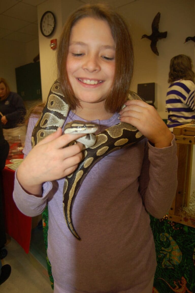 Clara Castle with a snake around her neck.