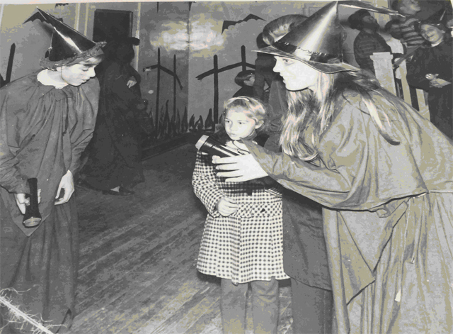 Witches lead visitors through the Guild’s haunted house. [Photo by Warwick High School annual staff]