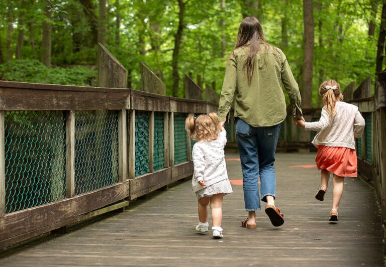 Mother and daughters walking boardwalk at the museum.